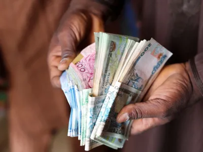 A man counts Nigerian naira notes in a market place as people struggle with the economic hardship and cashflow problems ahead of Nigeria's Presidential elections, in Yola, Nigeria, February 22, 2023. REUTERS/Esa Alexander