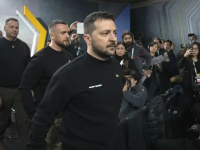Ukrainian President Volodymyr Zelenskyy leaves a hall after his press conference on the occasion of the Russia Ukraine war one year anniversary, in Kyiv, Ukraine, Friday, Feb. 24, 2023. (AP Photo/Efrem Lukatsky)