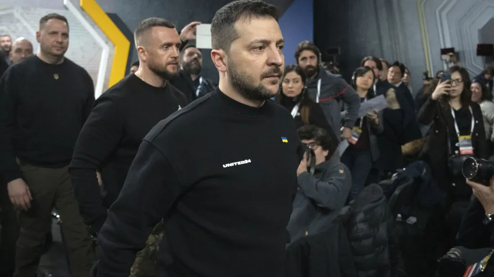 Ukrainian President Volodymyr Zelenskyy leaves a hall after his press conference on the occasion of the Russia Ukraine war one year anniversary, in Kyiv, Ukraine, Friday, Feb. 24, 2023. (AP Photo/Efrem Lukatsky)