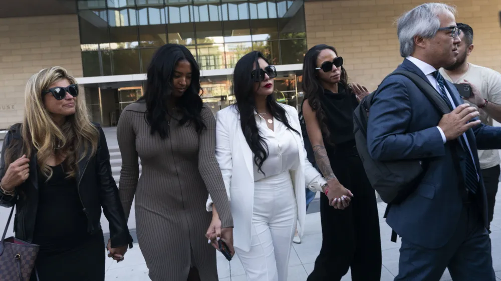 FILE - Vanessa Bryant, center, Kobe Bryant's widow, leaves a federal courthouse with her daughter Natalia, center left, soccer player Sydney Leroux, center right, in Los Angeles, Wednesday, Aug. 24, 2022. The family of the late Kobe Bryant has agreed to a $28.5 million settlement with Los Angeles County to resolve the remaining claims in a lawsuit over deputies and firefighters sharing grisly photos of the NBA star, his 13-year-old daughter and other victims killed in a 2020 helicopter crash, attorneys and court filings said Tuesday, Feb. 28, 2023. (AP Photo/Jae C. Hong, File)