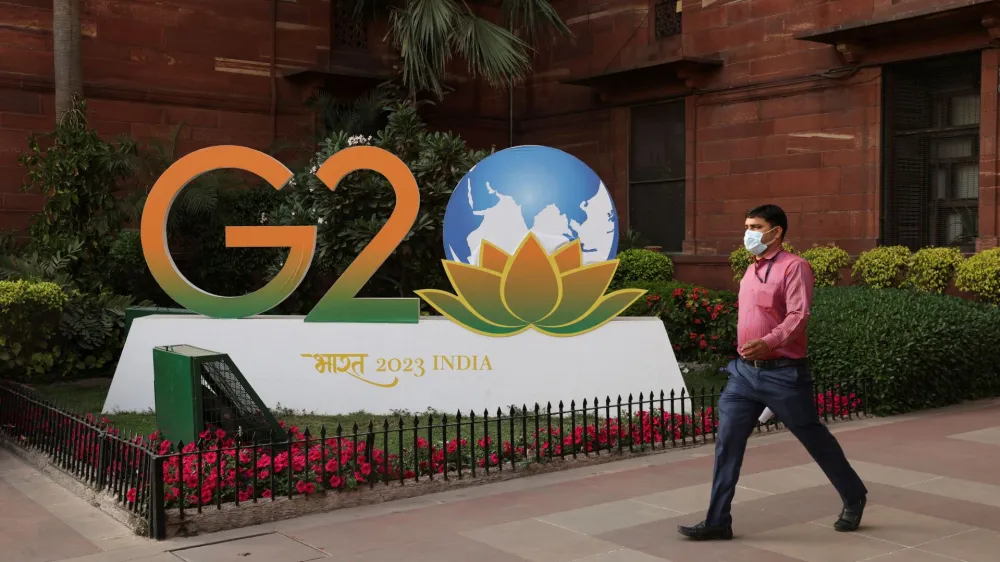 A man walks past a model of G20 logo outside the finance ministry in New Delhi, India, March 1, 2023. REUTERS/Anushree Fadnavis