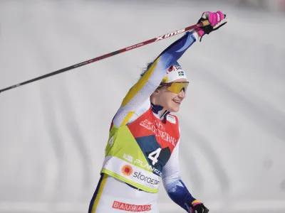 Sweden's Ebba Andersson celebrates her victory in the Women 30 km Mass Start Classic competition at the Nordic World Championships in Planica, Slovenia, Saturday, March 4, 2023. (AP Photo/Matthias Schrader)