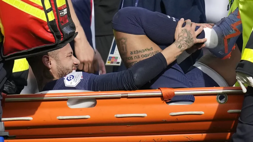 PSG's Neymar is carried off the field on a stretcher after after injuring during the French League One soccer match between Paris Saint-Germain and Lille at the Parc des Princes stadium, in Paris, France, Sunday, Feb. 19, 2023. (AP Photo/Christophe Ena)