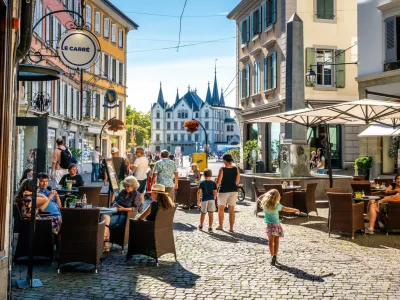 Vevey Switzerland, 4 July 2020: Scenic view of Vevey old town with people at cafe terrace and Aile castle in background on sunny summer day in Vevey Vaud Switzerland