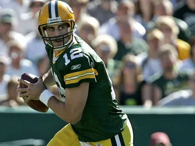 ﻿Green Bay Packers quarterback Aaron Rodgers rolls out to pass during the second quarter of an NFL preseason football game against the Tennessee Titans Friday, Sept. 1, 2006, in Green Bay, Wis. (AP Photo/ Mike Roemer)