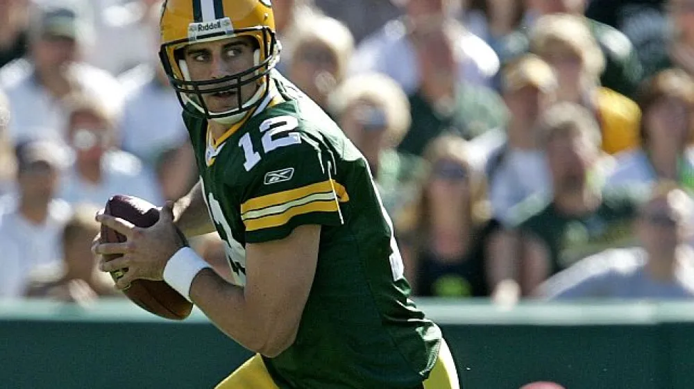 ﻿Green Bay Packers quarterback Aaron Rodgers rolls out to pass during the second quarter of an NFL preseason football game against the Tennessee Titans Friday, Sept. 1, 2006, in Green Bay, Wis. (AP Photo/ Mike Roemer)