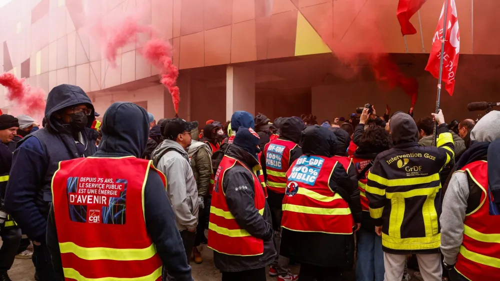 Striking workers stand in front of a power control center as they cut power to the large sports arena Stade de France and the Olympic village in the northern suburb of Saint-Ouen, near Paris, March 9, 2023. REUTERS/Noemie Olive