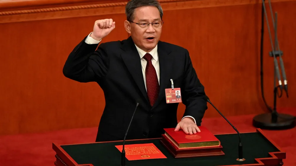 China's newly-elected Premier Li Qiang takes an oath after being elected during the fourth plenary session of the National People's Congress (NPC) at the Great Hall of the People in Beijing, China on March 11, 2023.   GREG BAKER/Pool via REUTERS