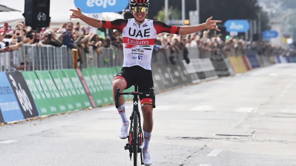 Tadej Pogacar celebrates as he crosses the finish line to win Il Lombardia cycling race from Bergamo to Como, Italy, Saturday, Oct. 8, 2022. (Gian Mattia D'Alberto/LaPresse via AP)