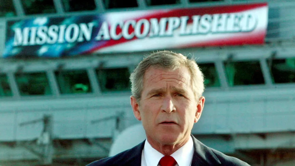 FILE PHOTO: The White House said on October 29, 2003 that it had helped with the production of a "Mission Accomplished" banner as a backdrop for President George W. Bush's speech onboard the USS Abraham Lincoln to declare combat operations over in Iraq. This file photo shows Bush delivering a speech to crew aboard the aircraft carrier USS Abraham Lincoln, as the carrier steamed toward San Diego, California on May 1, 2003. REUTERS/Larry Downing/FILE  KL/GN/GAC/File Photo