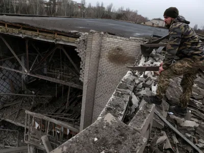 Pavlo, a Ukrainian soldier, stands on the roof of a damaged university, as Russia's attack on Ukraine continues, from a recent missile attack in Kramatorsk Ukraine, December 13, 2022. REUTERS/Shannon Stapleton REFILE - CORRECTING ID