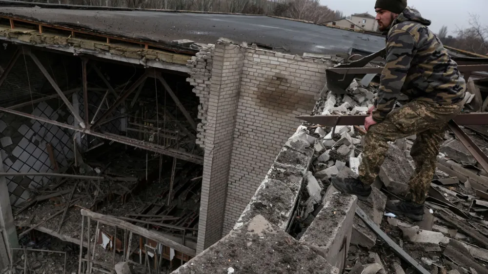 Pavlo, a Ukrainian soldier, stands on the roof of a damaged university, as Russia's attack on Ukraine continues, from a recent missile attack in Kramatorsk Ukraine, December 13, 2022. REUTERS/Shannon Stapleton REFILE - CORRECTING ID
