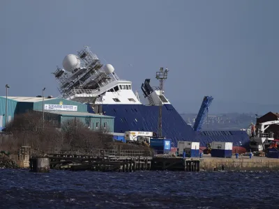 22 March 2023, United Kingdom, Leith: A view of the ship Petrel at Imperial Dock in Leith, which has become dislodged from its holding and is partially toppled over. Fifteen people were taken to hospital while a further 10 patients were treated and discharged after the incident this morning. Photo: Andrew Milligan/PA Wire/dpa