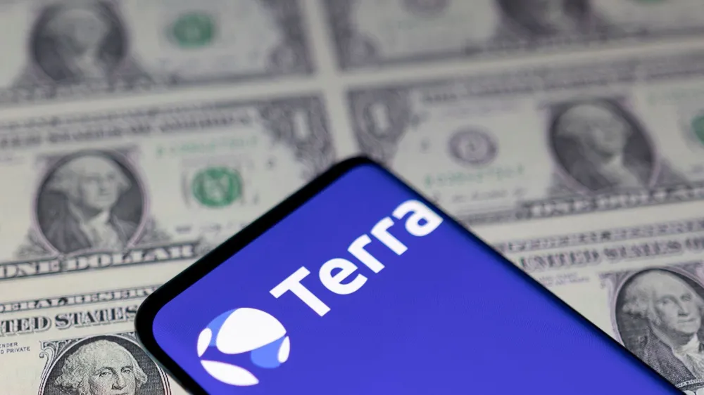 FILE PHOTO: Smartphone with Terra logo is placed on displayed U.S. dollars in this illustration taken May 11, 2022. REUTERS/Dado Ruvic/Illustration/File Photo