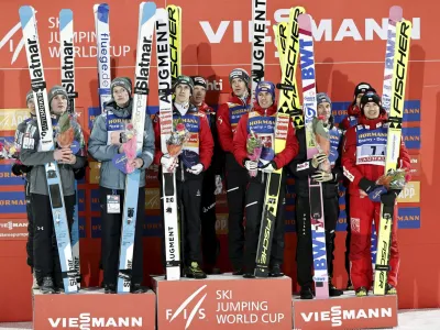 Nordic Skiing - FIS Nordic World Cup Lahti Ski Games - Lahti, Finland - March 25, 2023 Team Austria celebrate on the podium after winning the men's HS130 ski jumping alongside Team Slovenia and third-placed team Poland Antti Hamalainen/Lehtikuva via REUTERS ATTENTION EDITORS - THIS IMAGE WAS PROVIDED BY A THIRD PARTY. NO THIRD PARTY SALES. NOT FOR USE BY REUTERS THIRD PARTY DISTRIBUTORS. FINLAND OUT. NO COMMERCIAL OR EDITORIAL SALES IN FINLAND.