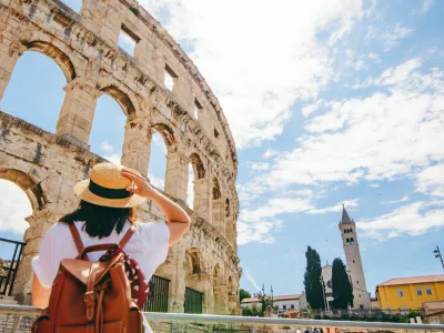 woman looking at coliseum in Pula, Croatia. summer vacation. famous landmark