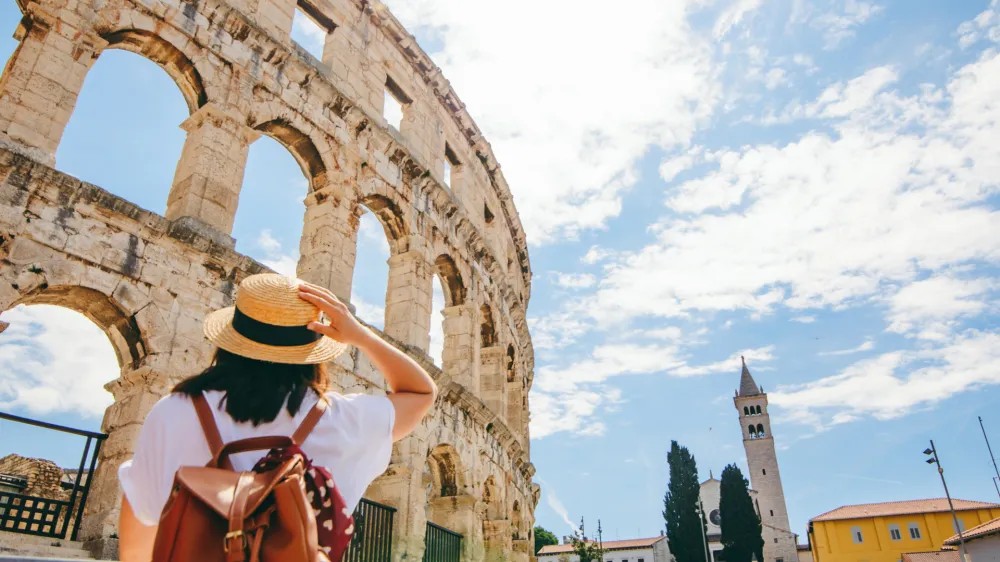 woman looking at coliseum in Pula, Croatia. summer vacation. famous landmark