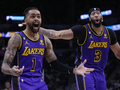 Los Angeles Lakers guard D'Angelo Russell (1) and forward Anthony Davis (3) react to a call during the second half of the team's NBA basketball game against the Minnesota Timberwolves, Friday, March 31, 2023, in Minneapolis. (AP Photo/Abbie Parr)
