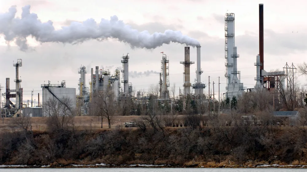 The Tesoro oil refinery is shown in operation on the west bank of the Missouri River in Mandan, N.D., on Tuesday, Dec. 13, 2005. Parts of the Bismarck-Mandan area had some of the worst air in the nation in terms of health risk from industrial air polution in 2000, a new analysis by the Associated Press shows. (AP Photo/Will Kincaid)