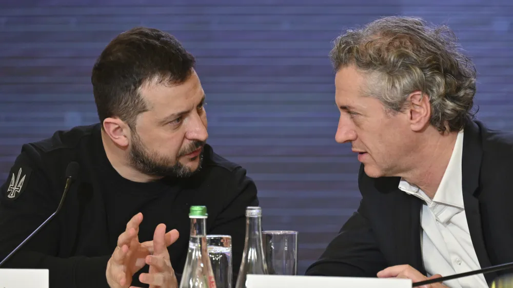 In this photo provided by the Ukrainian Presidential Press Office, Ukrainian President Volodymyr Zelenskyy, left, speaks to Slovenian Prime Minister Robert Golob during the Bucha Summit in Kyiv, Ukraine, Friday, March 31, 2023. (Ukrainian Presidential Press Office via AP)