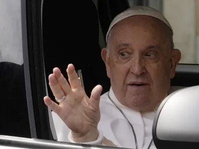 Pope Francis waves from his car as he arrives at The Vatican, Saturday, April 1, 2023, after receiving treatment at the Agostino Gemelli University Hospital for bronchitis, The Vatican said. Francis was hospitalized on Wednesday after his public general audience in St. Peter's Square at The Vatican. (AP Photo/Andrew Medichini)