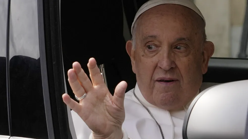 Pope Francis waves from his car as he arrives at The Vatican, Saturday, April 1, 2023, after receiving treatment at the Agostino Gemelli University Hospital for bronchitis, The Vatican said. Francis was hospitalized on Wednesday after his public general audience in St. Peter's Square at The Vatican. (AP Photo/Andrew Medichini)