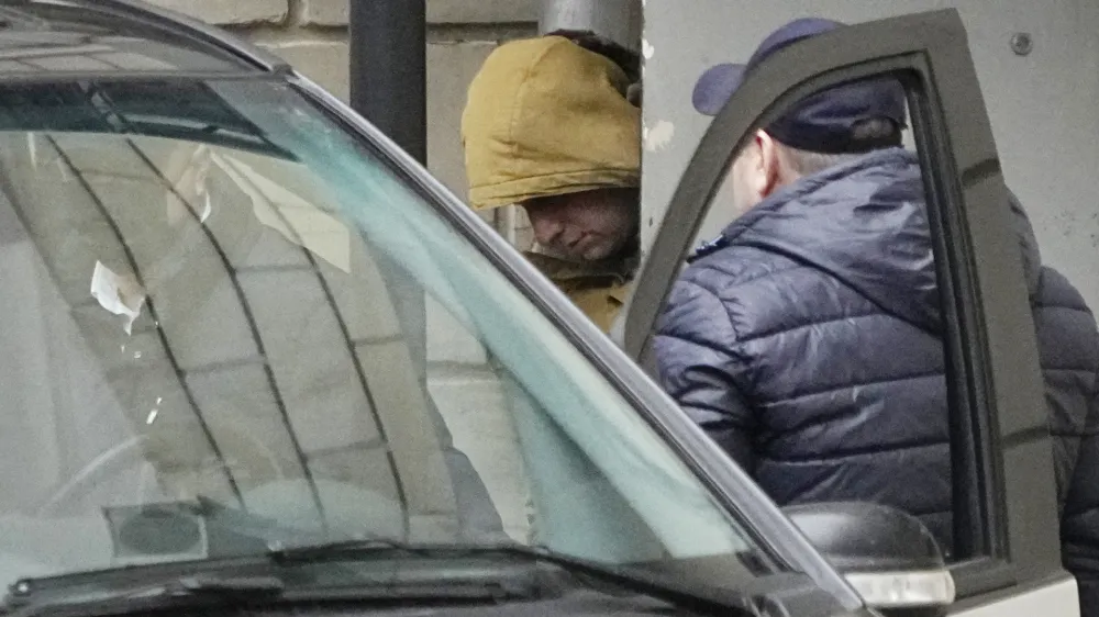 FILE - Wall Street Journal reporter Evan Gershkovich is escorted by officers from the Lefortovsky court to a bus, in Moscow, Russia, Thursday, March 30, 2023. Secretary of State Antony Blinken urged his Russian counterpart, in a rare phone since the Ukraine war, to immediately release Gershkovich, who was detained last week, as well as another imprisoned American, Paul Whelan, the State Department said Sunday, April 2. (AP Photo/Alexander Zemlianichenko, File)