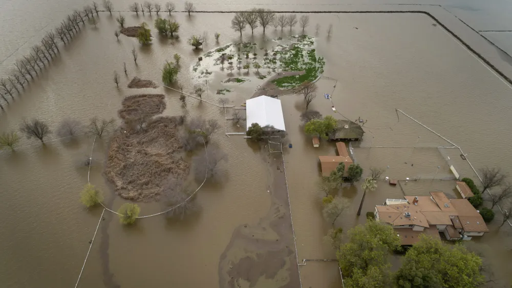 FILE - A home sits in rising floodwaters after a levee break caused extensive flooding around Corcoran, Calif., on Tuesday, March 21, 2023. (Carlos Avila Gonzalez/San Francisco Chronicle via AP, File)