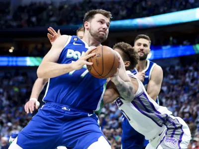 Apr 5, 2023; Dallas, Texas, USA; Dallas Mavericks guard Luka Doncic (77) looks to score as Sacramento Kings small forward Kessler Edwards (17) defends during the first quarter at American Airlines Center. Mandatory Credit: Kevin Jairaj-USA TODAY Sports