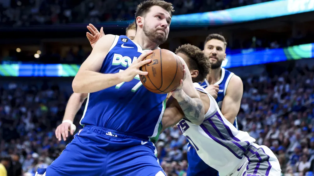 Apr 5, 2023; Dallas, Texas, USA; Dallas Mavericks guard Luka Doncic (77) looks to score as Sacramento Kings small forward Kessler Edwards (17) defends during the first quarter at American Airlines Center. Mandatory Credit: Kevin Jairaj-USA TODAY Sports