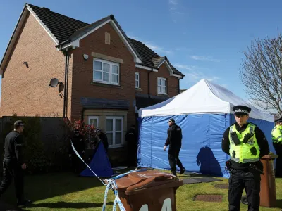 Police officers stand outside the house of Peter Murrell, the former SNP Chief Executive and husband to former Scotland's First Minister Nicola Sturgeon, in Glasgow, Scotland, Britain, April 6, 2023. REUTERS/Russell Cheyne