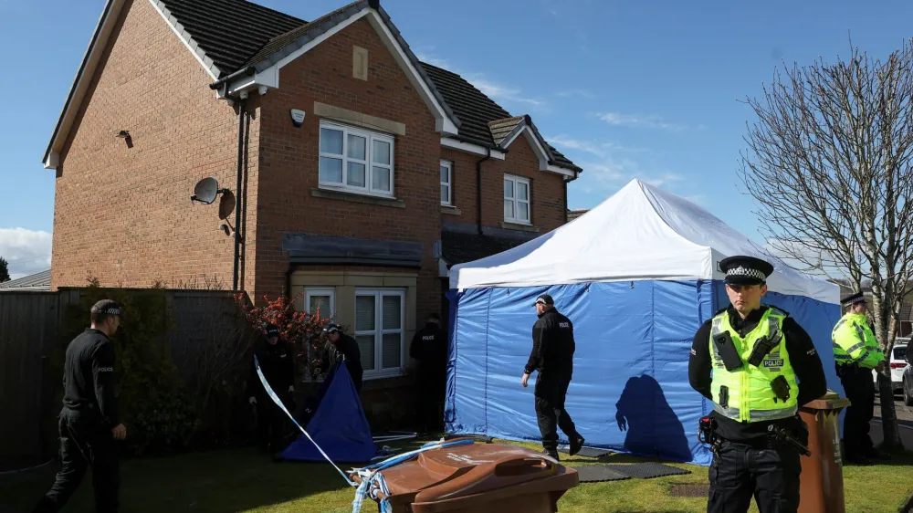 Police officers stand outside the house of Peter Murrell, the former SNP Chief Executive and husband to former Scotland's First Minister Nicola Sturgeon, in Glasgow, Scotland, Britain, April 6, 2023. REUTERS/Russell Cheyne