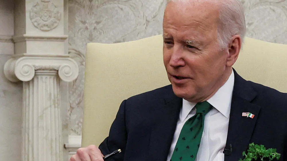 FILE PHOTO: U.S. President Joe Biden speaks while hosting a virtual St. Patrick's Day meeting with Ireland's Prime Minister Micheal Martin after Irish Taoiseach Martin tested positive for coronavirus disease (COVID-19) after arriving in Washington, in the Oval Office at the White House in Washington, U.S., March 17, 2022. REUTERS/Leah Millis/File Photo