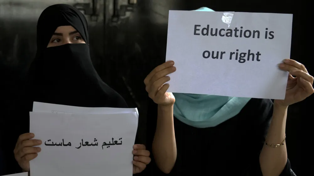 Afghan girls hold illegal protest to demand the right to education in a private home in Kabul, Afghanistan, Tuesday, Aug. 2, 2022. For most teenage girls in Afghanistan, it's been a year since they set foot in a classroom. With no sign the ruling Taliban will allow them back to school, some girls and parents are trying to find ways to keep education from stalling for a generation of young women. (AP Photo/Ebrahim Noroozi)