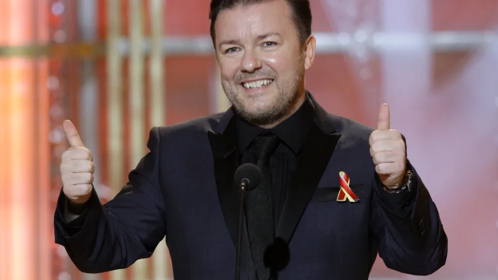 FILE - In this Jan. 17, 2010 file photo released by NBC, host Ricky Gervais gestures on stage during the 67th Annual Golden Globe Awards held at the Beverly Hilton Hotel. (AP Photo/NBC, Paul Drinkwater, file)