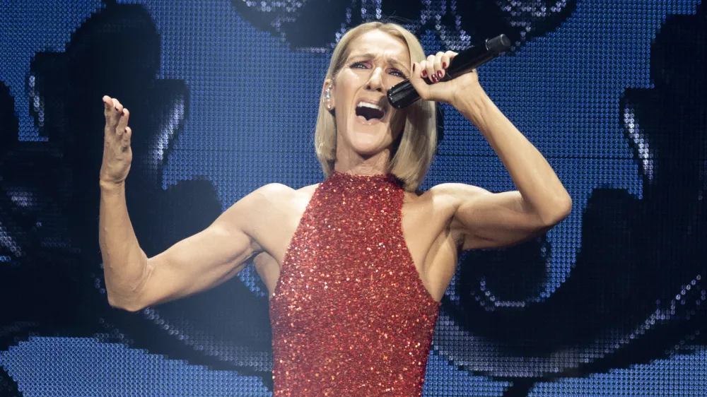 FILE - Singer Celine Dion performs during her Courage tour in Quebec City on Sept. 18, 2019. Dion has put a halt on all performing after being diagnosed with a rare neurological disorder. In video messages posted in French and English on Thursday on Instagram, Dion said Stiff-Person Syndrome was causing spasms that affect her ability to walk and sing. (Jacques Boissinot/The Canadian Press via AP, File)