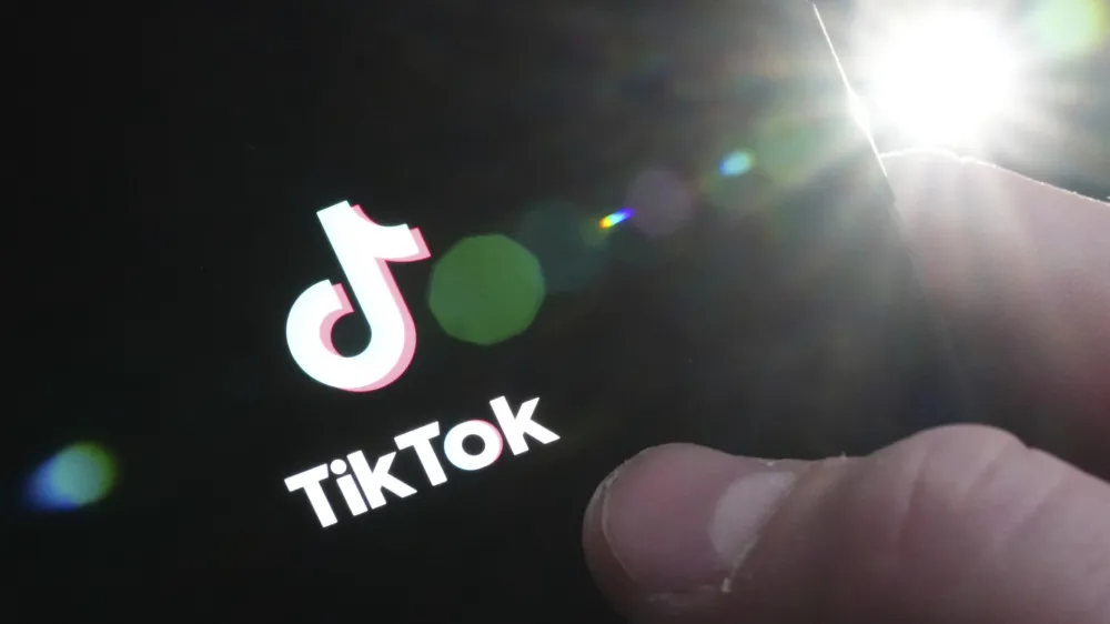 The TikTok startup page is displayed on an iPhone in Ottawa, Ontario, Monday, Feb. 27, 2023. The federal government is banning TikTok from its mobile devices just days after federal and provincial privacy commissioners launched an investigation into the social media platform. (Sean Kilpatrick/The Canadian Press via AP)