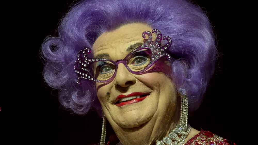 FILE - Australian TV presenter Barry Humphries performs on stage as Dame Edna for the Farewell Tour, at the London Palladium theatre, in central London, on Nov. 13, 2013. Tony Award-winning comedian Barry Humphries, internationally renowned for his garish stage persona Dame Edna Everage, a condescending and imperfectly-veiled snob whose evolving character has delighted audiences over seven decades, died on Saturday, April 22, 2023, after spending several days in a Sydney hospital with complications following hip surgery, a Sydney hospital said. He was 89 years old. (Photo by Joel Ryan/Invision/AP, File)