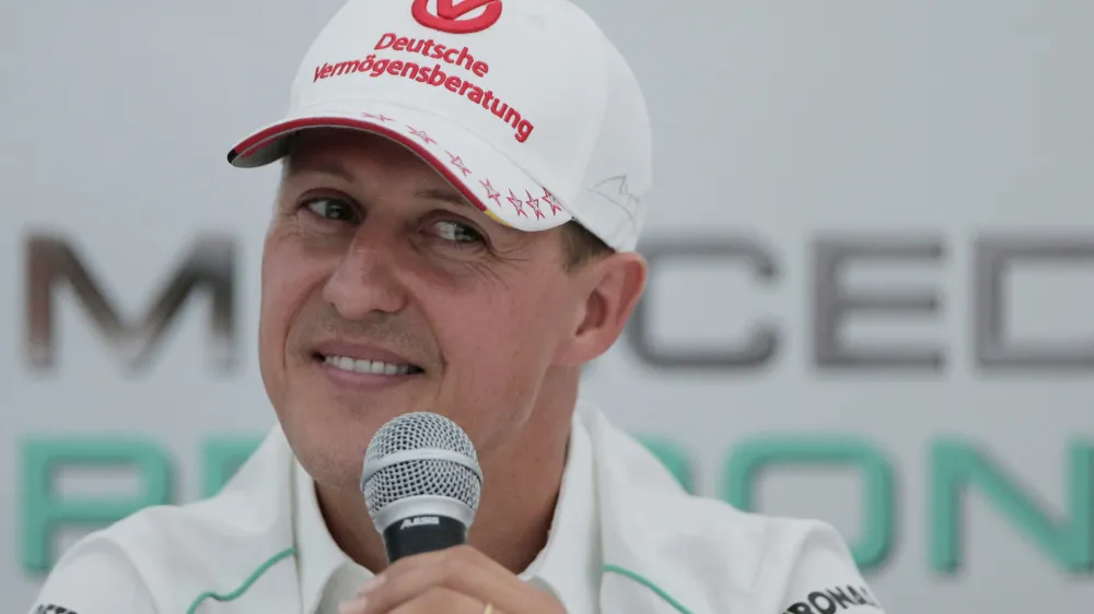 FILE - Michael Schumacher announces his retirement from Formula One during a press conference at the Suzuka Circuit venue for the Japanese Formula One Grand Prix in Suzuka, Japan, Oct. 4, 2012. The family of Formula One great Michael Schumacher plans to take legal action against a German magazine for publishing what it claimed to be an artificial intelligence-generated interview with Schumacher. Family spokesperson Sabine Kehm confirmed to The Associated Press by email on Thursday, April 20, 2023, that legal action is being planned over a "fake artificial intelligence interview by German outlet Die Aktuelle." (AP Photo/Itsuo Inouye, file)