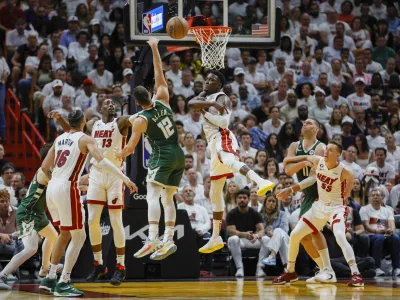 Apr 22, 2023; Miami, Florida, USA; Miami Heat guard Victor Oladipo (4) blocks the shot of Milwaukee Bucks guard Grayson Allen (12) in the fourth quarter during game three of the 2023 NBA Playoffs at Kaseya Center. Mandatory Credit: Sam Navarro-USA TODAY Sports