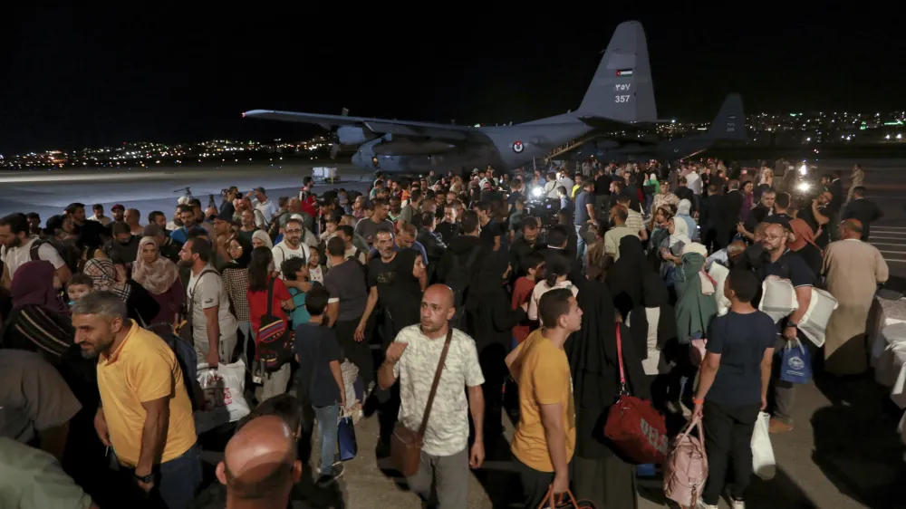 Jordanians evacuated from Sudan arrive at a military airport in Amman, Jordan, Monday, April 24, 2023. (AP Photo/Raad Adayleh)