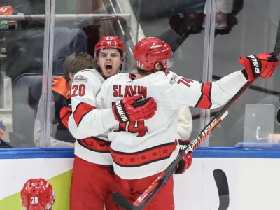 Apr 28, 2023; Elmont, New York, USA; Carolina Hurricanes center Sebastian Aho (20) celebrates with defenseman Jaccob Slavin (74) after scoring a game tying goal in the third period in game six of the first round of the 2023 Stanley Cup Playoffs against the New York Islanders at UBS Arena. Mandatory Credit: Wendell Cruz-USA TODAY Sports