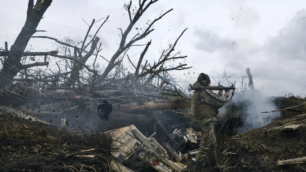 A Ukrainian soldier fires an RPG toward Russian positions at the frontline near Avdiivka, an eastern city where fierce battles against Russian forces have been taking place, in the Donetsk region, Ukraine, Friday, April 28, 2023. (AP Photo/Libkos)