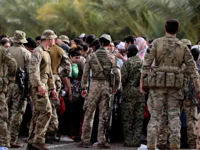 Military personnel gather during the evacuation of British citizens, at Wadi Seidna airport, Sudan April 26, 2023. Arron Hoare/UK MOD/Handout via REUTERS THIS IMAGE HAS BEEN SUPPLIED BY A THIRD PARTY