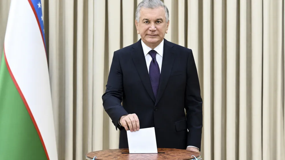 In this handout photo released by Uzbekistan's Presidential Press Office, Uzbekistan's President Shavkat Mirziyoyev casts his ballot at a polling station during a referendum in Tashkent, Uzbekistan, Sunday, April 30, 2023. Voters in Uzbekistan are casting ballots in a referendum on a revised constitution that promises human rights reforms. But the reforms being voted on Sunday also would allow the country's president to stay in office until 2040.(Uzbekistan's Presidential Press Office via AP)