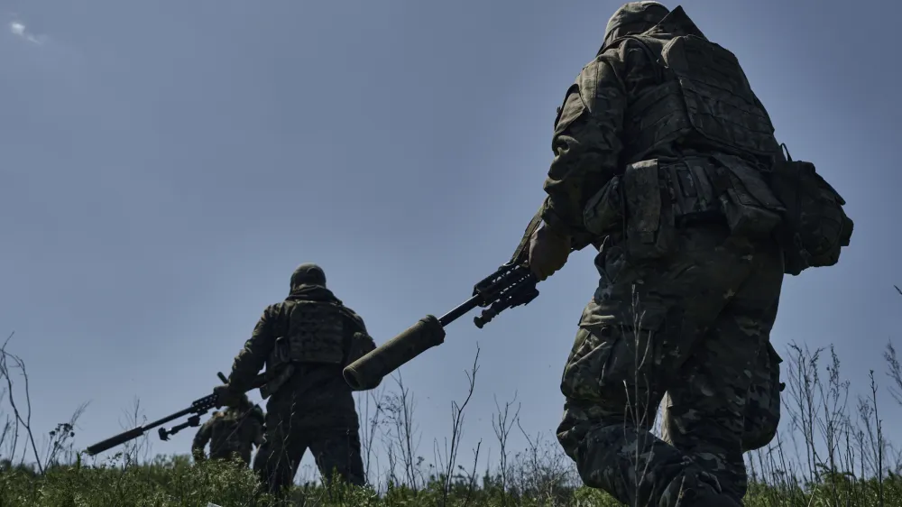 Ukrainian army snipers change their position facing Russian troops near Bakhmut, Donetsk region, Ukraine, Tuesday, May 2, 2023. (AP Photo/Libkos)