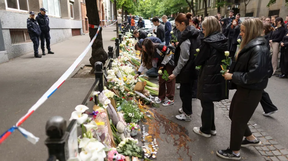 People lay tributes following a school mass shooting, after a boy opened fire on others, killing fellow students and staff in Belgrade, Serbia, May 4, 2023. REUTERS/Antonio Bronic