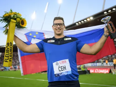 Kristjan Ceh of Slovenia celebrates with the Diamond League Trophy after winning the Discus Throw Men during the Weltklasse IAAF Diamond League international athletics meeting at the Letzigrund stadium in Zurich, Switzerland, Thursday, Sept. 8, 2022. (Jean-Christophe Bott/Keystone via AP)