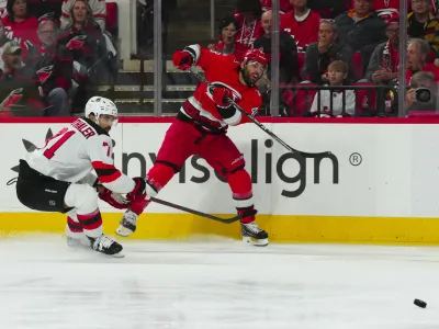 May 5, 2023; Raleigh, North Carolina, USA; Carolina Hurricanes left wing Jordan Martinook (48) takes a shot against New Jersey Devils defenseman Jonas Siegenthaler (71) during the first period in game two of the second round of the 2023 Stanley Cup Playoffs at PNC Arena. Mandatory Credit: James Guillory-USA TODAY Sports