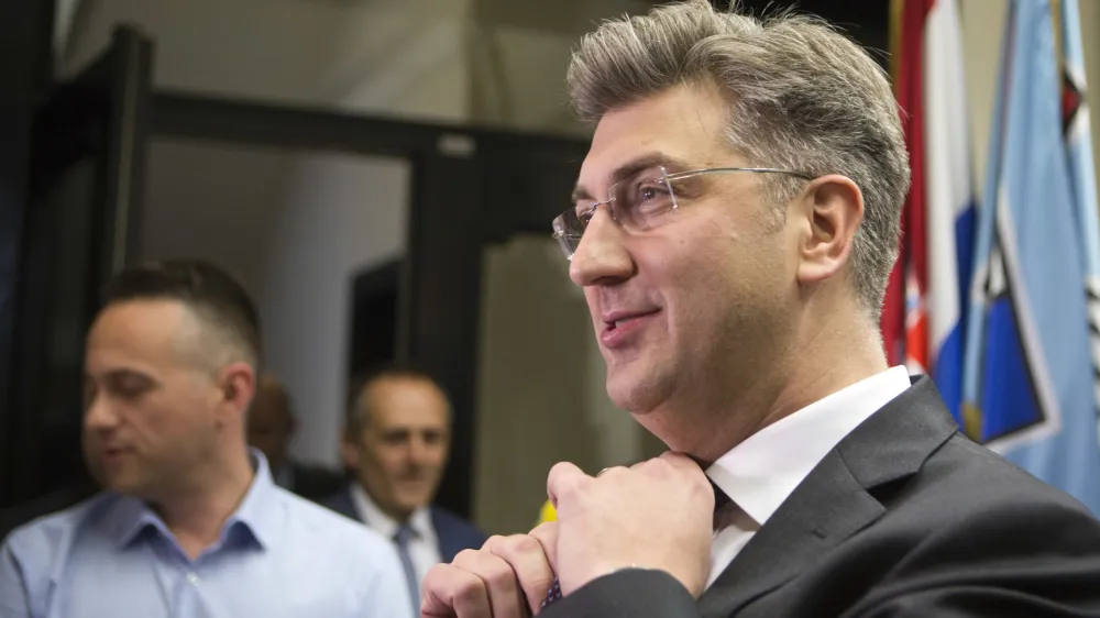 ﻿Croatia's Prime Minister, Andrej Plenkovic, adjusts his tie before addressing the media at his party headquarters in Zagreb, Croatia, Thursday, April 27, 2017. Plenkovic has moved to replace three ministers from a junior party in the government, triggering a crisis in the ruling conservative coalition. (AP Photo/Darko Bandic)